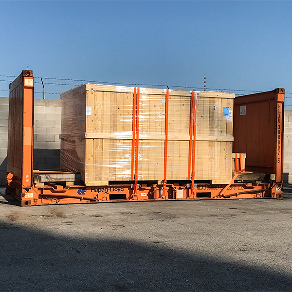 Crated cargo secured on a flat rack container