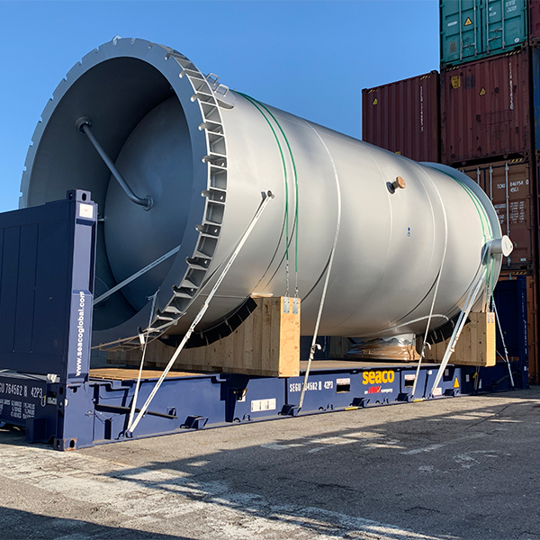Large cylindrical project cargo secured on a flat rack