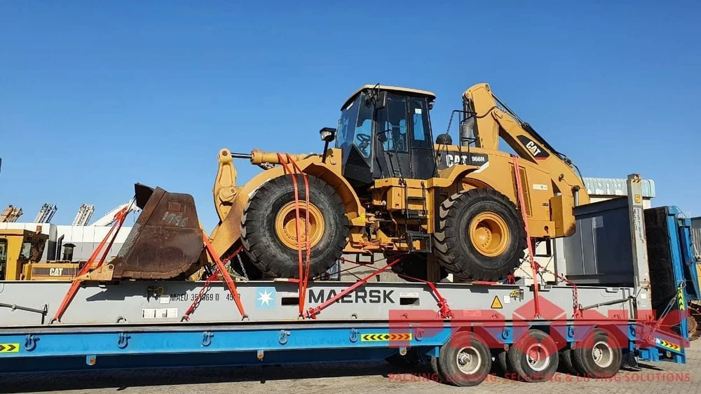 Wheel loader secured for transport on a flat rack
